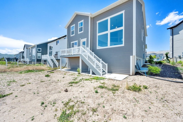 12297 S Boggs Way, Herriman, UT 84096 - rear view of house featuring stairway, a deck, and a residential view