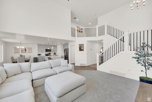 12297 S Boggs Way, Herriman, UT 84096 - living area with a chandelier, a high ceiling, stairway, baseboards, and recessed lighting