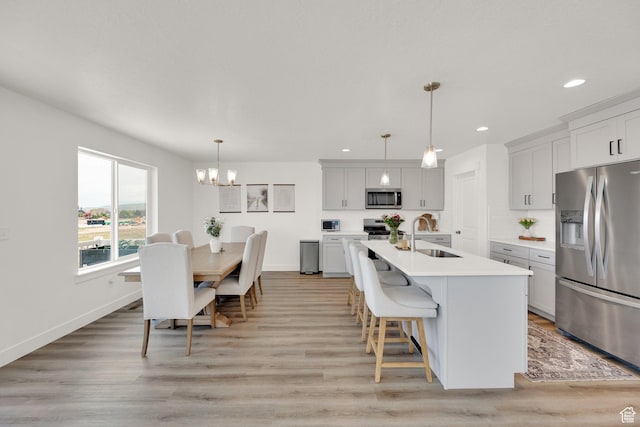 12297 S Boggs Way, Herriman, UT 84096 - kitchen with appliances with stainless steel finishes, a sink, light countertops, a chandelier, and recessed lighting