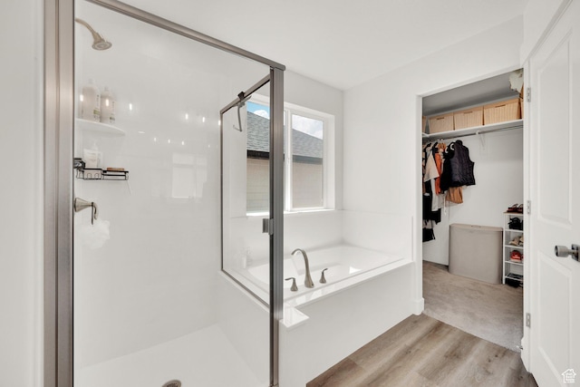 12297 S Boggs Way, Herriman, UT 84096 - full bath featuring a stall shower, a bath, wood finished floors, and a spacious closet