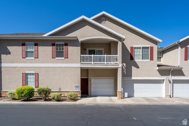 1052 S Canyon Meadows Dr Unit 4, Provo, UT 84606 - townhome / multi-family property with stucco siding, an attached garage, a balcony, and driveway