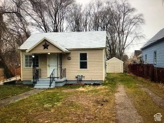 1419 S Grant, Ogden, UT 84404 - bungalow featuring dirt driveway, a detached garage, and an outdoor structure