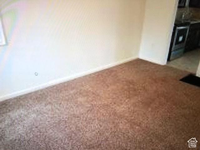 1419 S Grant, Ogden, UT 84404 - empty room featuring dark colored carpet and baseboards