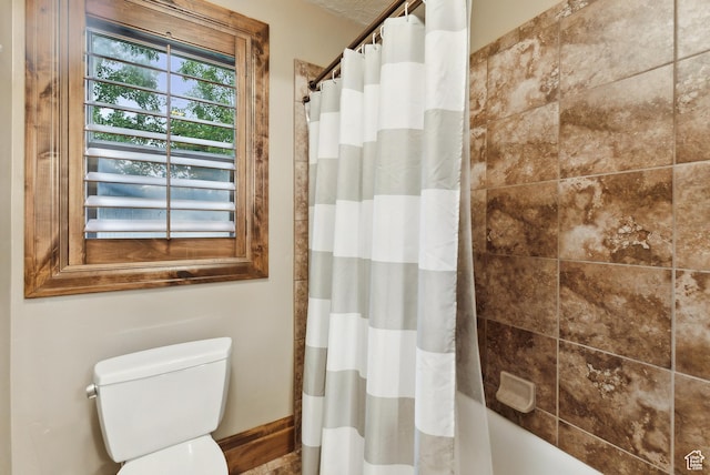 5964 S Ragsdale Dr E, Murray, UT 84121 - full bathroom featuring toilet, shower / bath combination with curtain, and baseboards