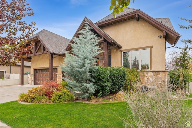 5964 S Ragsdale Dr E, Murray, UT 84121 - view of front of house with stone siding, driveway, a garage, stucco siding, and roof with shingles