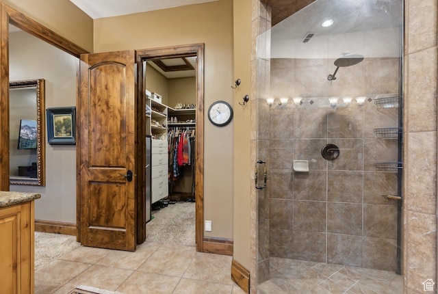 5964 S Ragsdale Dr E, Murray, UT 84121 - bathroom featuring tiled shower, vanity, a walk in closet, and tile patterned floors
