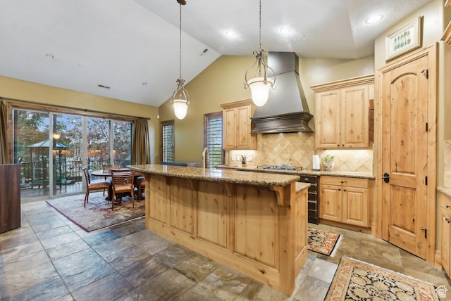 5964 S Ragsdale Dr E, Murray, UT 84121 - kitchen featuring custom range hood, light brown cabinets, light stone counters, decorative backsplash, and a center island