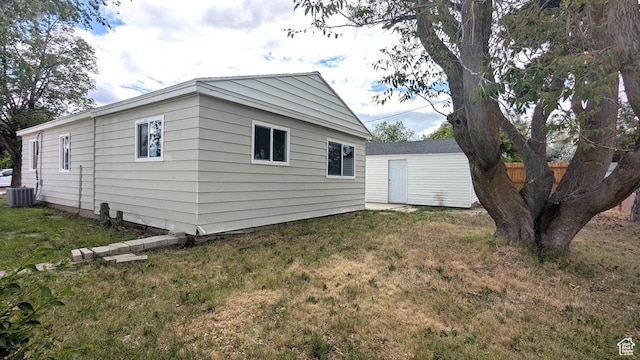 4650 W Mildred St, Kearns, UT 84118 - view of side of home featuring a lawn and central AC unit