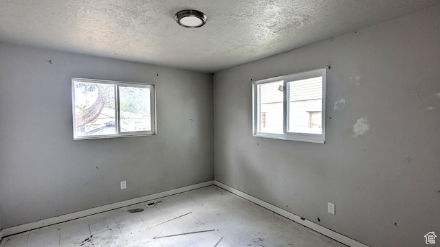 4650 W Mildred St, Kearns, UT 84118 - unfurnished room featuring baseboards, a textured ceiling, and tile patterned floors