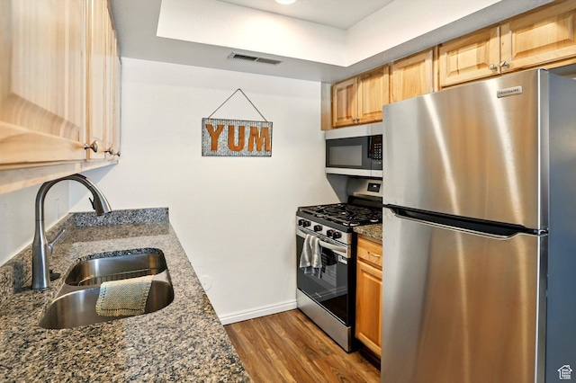 875 E Arrowhead Ln S Unit 3, Murray, UT 84107 - kitchen featuring stainless steel appliances, a sink, dark wood-style floors, baseboards, and dark stone countertops