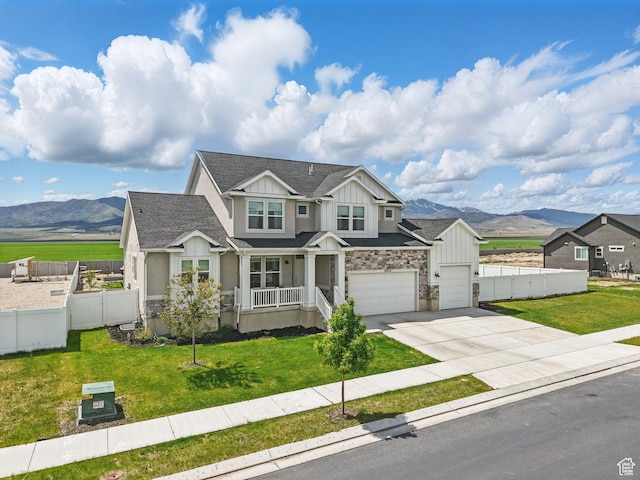 4823 N Canaan Peak Dr W, Eagle Mountain, UT 84005 - craftsman inspired home with board and batten siding, a mountain view, concrete driveway, and roof with shingles