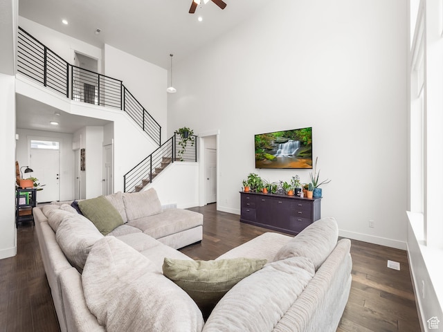 4823 N Canaan Peak Dr W, Eagle Mountain, UT 84005 - living room featuring a high ceiling, a ceiling fan, stairway, baseboards, and dark wood-style floors
