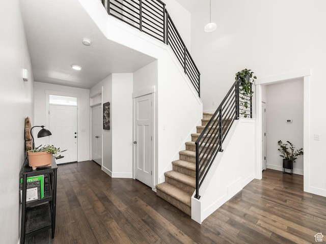 4823 N Canaan Peak Dr W, Eagle Mountain, UT 84005 - foyer featuring stairway, dark wood finished floors, baseboards, and a towering ceiling