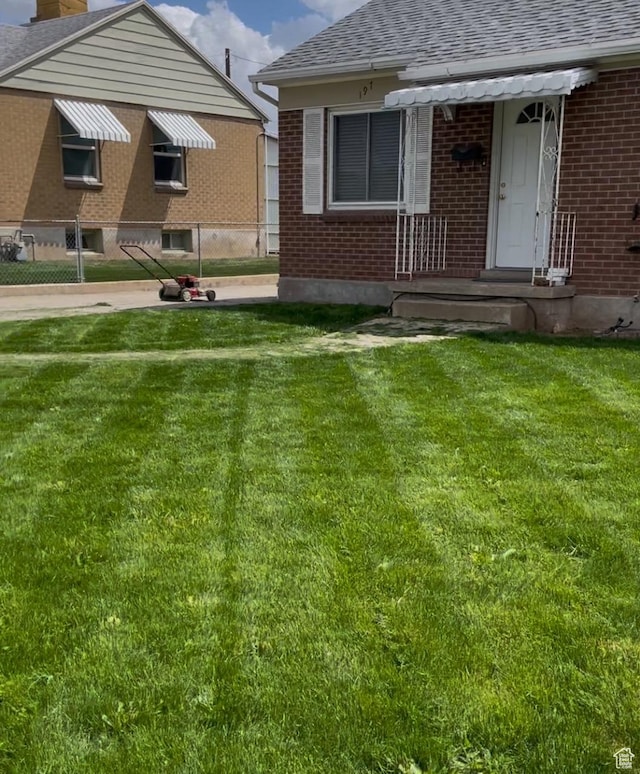 197 Ross Dr Lot 6, Clearfield, UT 84015 - view of front of home featuring brick siding, roof with shingles, a chimney, and a front yard
