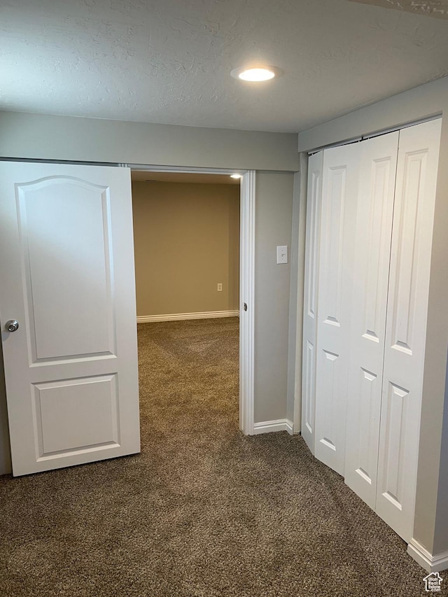 197 Ross Dr Lot 6, Clearfield, UT 84015 - hallway with dark carpet and baseboards