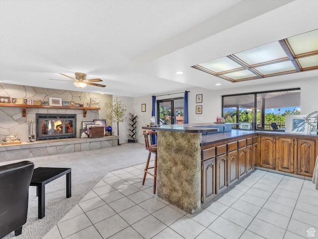 5104 Shawnee Ln, Ogden, UT 84403 - kitchen with healthy amount of natural light, a breakfast bar area, dark countertops, open floor plan, and recessed lighting