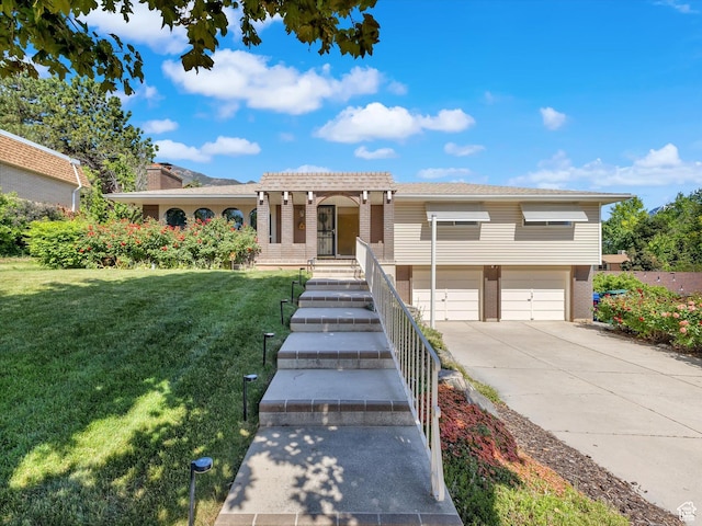 5104 Shawnee Ln, Ogden, UT 84403 - view of front facade with an attached garage, driveway, a front lawn, and brick siding