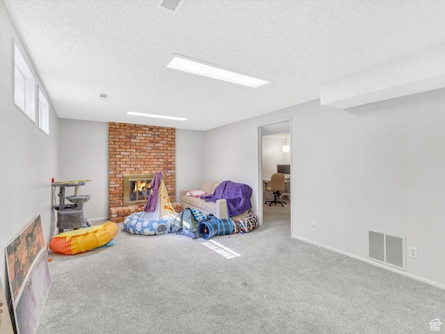 5104 Shawnee Ln, Ogden, UT 84403 - playroom featuring carpet floors, a textured ceiling, a fireplace, baseboards, and a desk