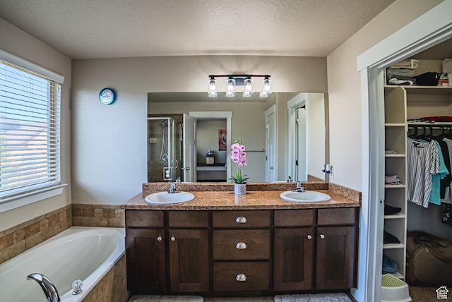 3907 W Tottori Dune Dr S, South Jordan, UT 84095 - full bath featuring a shower stall, a garden tub, a spacious closet, double vanity, and a textured ceiling
