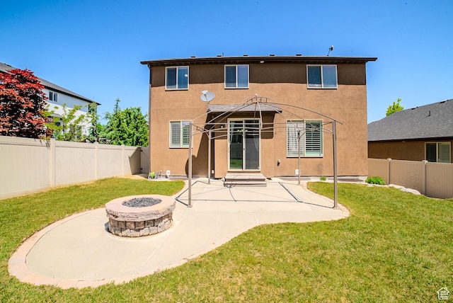 3907 W Tottori Dune Dr S, South Jordan, UT 84095 - rear view of house featuring stucco siding, a fire pit, and a patio area