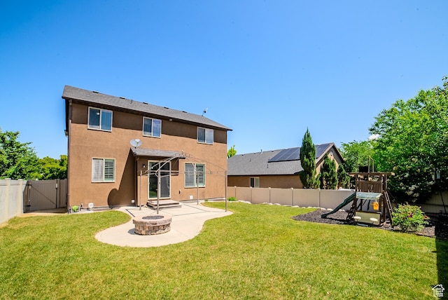 3907 W Tottori Dune Dr S, South Jordan, UT 84095 - back of house featuring a playground, a gate, a patio area, stucco siding, and an outdoor fire pit