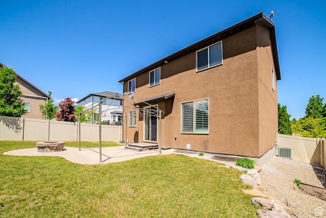 3907 W Tottori Dune Dr S, South Jordan, UT 84095 - rear view of house with a fire pit, a patio, stucco siding, and central AC