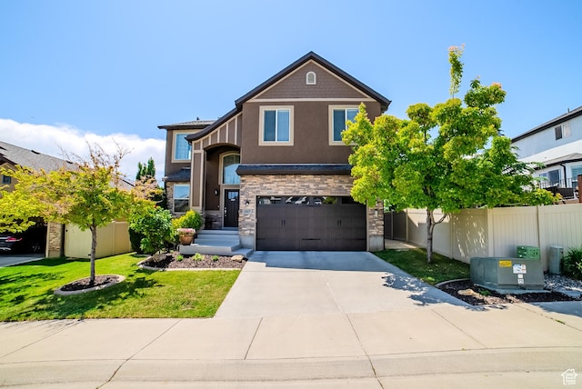 3907 W Tottori Dune Dr S, South Jordan, UT 84095 - view of front of home featuring concrete driveway, an attached garage, stone siding, and stucco siding