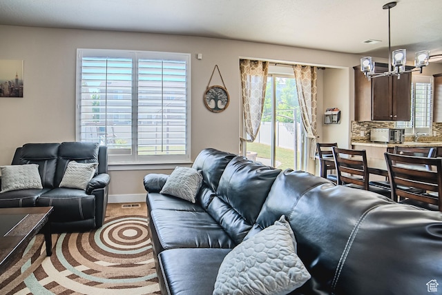 3907 W Tottori Dune Dr S, South Jordan, UT 84095 - living area with a chandelier, baseboards, and carpet floors