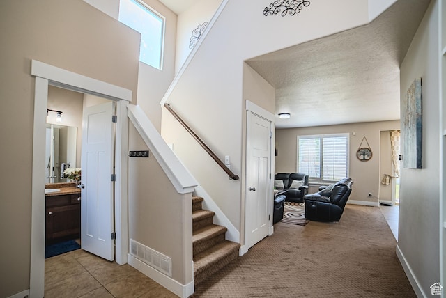 3907 W Tottori Dune Dr S, South Jordan, UT 84095 - staircase with tile patterned floors, baseboards, and carpet floors