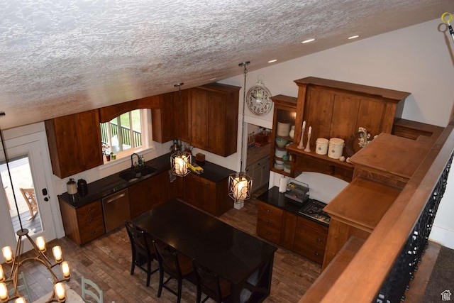 4633 E Glendale Rd, Preston, ID 83263 - kitchen featuring a textured ceiling, dark wood-style floors, a sink, dark countertops, and brown cabinetry