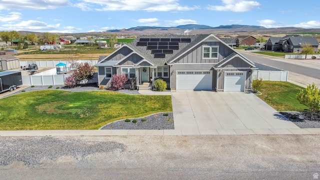 495 E 100 S, Centerfield, UT 84622 - craftsman house with board and batten siding, solar panels, driveway, a mountain view, and an attached garage