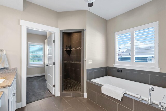 495 E 100 S, Centerfield, UT 84622 - full bathroom featuring a bath, vanity, a shower stall, tile patterned flooring, and baseboards