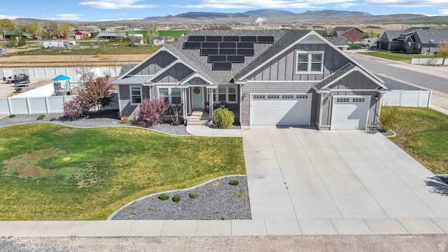 495 E 100 S, Centerfield, UT 84622 - craftsman house featuring board and batten siding, roof mounted solar panels, a mountain view, driveway, and roof with shingles