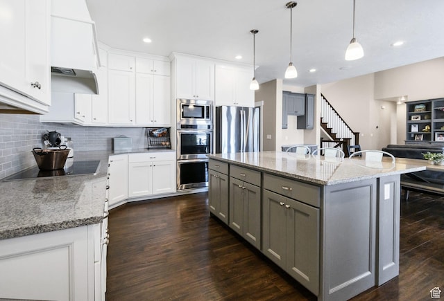 495 E 100 S, Centerfield, UT 84622 - kitchen with gray cabinets, appliances with stainless steel finishes, light stone countertops, decorative backsplash, and dark wood-style flooring