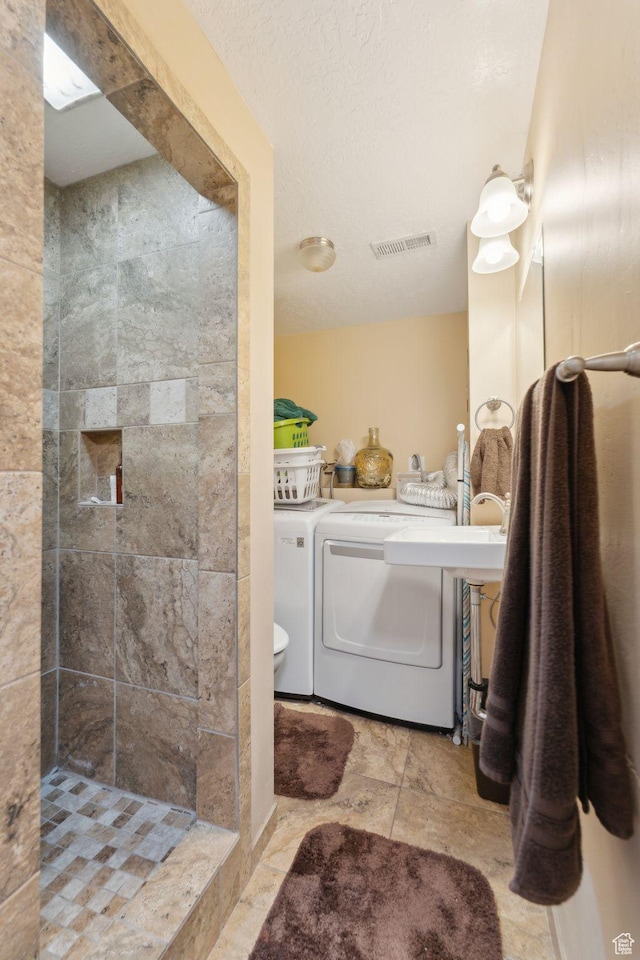 5748 S 3975 W, Roy, UT 84067 - bathroom featuring tiled shower, washer and dryer, and toilet