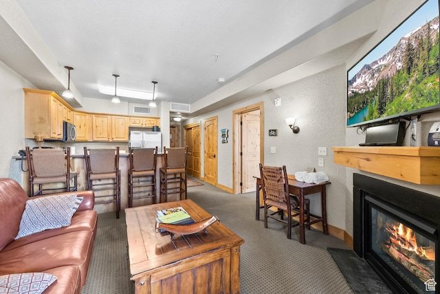 2669 Canyons Resort Dr Unit 304A, Park City, UT 84098 - living room featuring a glass covered fireplace, light colored carpet, a textured wall, and baseboards