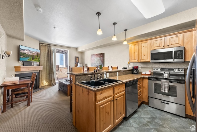 2669 Canyons Resort Dr Unit 304A, Park City, UT 84098 - kitchen featuring appliances with stainless steel finishes, a sink, a peninsula, decorative light fixtures, and a breakfast bar