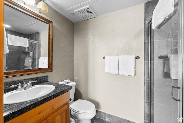 2669 Canyons Resort Dr Unit 304A, Park City, UT 84098 - bathroom with vanity, a shower stall, toilet, a textured wall, and tile patterned flooring