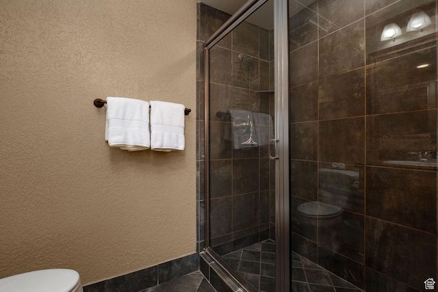 2669 Canyons Resort Dr Unit 304A, Park City, UT 84098 - bathroom featuring toilet, a shower stall, and a textured wall