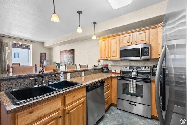 2669 Canyons Resort Dr Unit 304A, Park City, UT 84098 - kitchen with appliances with stainless steel finishes, a sink, a peninsula, hanging light fixtures, and dark stone counters