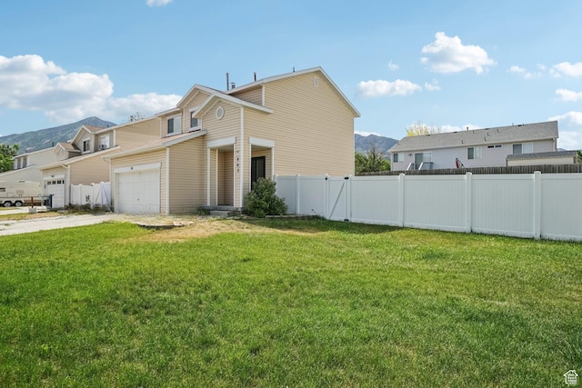 802 E 580 N, Tooele, UT 84074 - view of front of home with driveway, a garage, and a mountain view