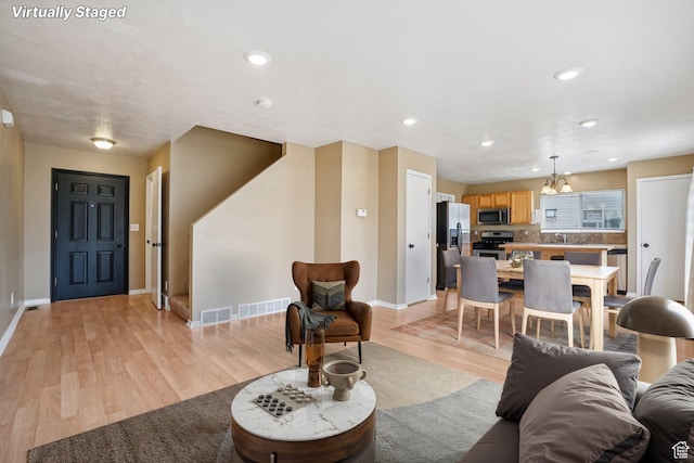 802 E 580 N, Tooele, UT 84074 - living room featuring light wood-style floors, baseboards, and recessed lighting