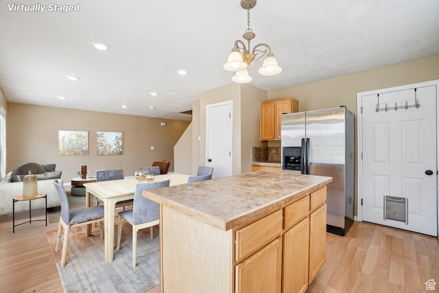 802 E 580 N, Tooele, UT 84074 - kitchen with stainless steel refrigerator with ice dispenser, light wood finished floors, a chandelier, open floor plan, and light brown cabinetry