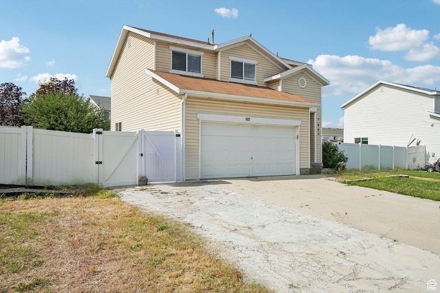802 E 580 N, Tooele, UT 84074 - traditional-style home with a gate, concrete driveway, and an attached garage