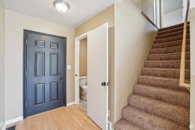 802 E 580 N, Tooele, UT 84074 - entrance foyer featuring stairs, light wood finished floors, and baseboards