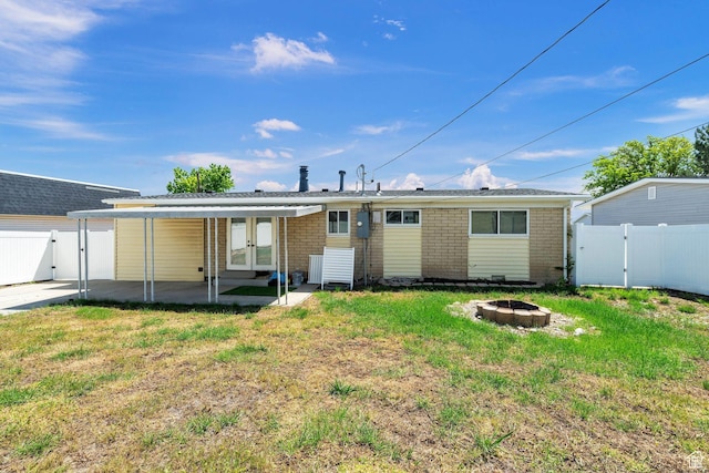 5230 S 5200 W, Kearns, UT 84118 - back of house with french doors, a gate, a fire pit, a patio area, and brick siding