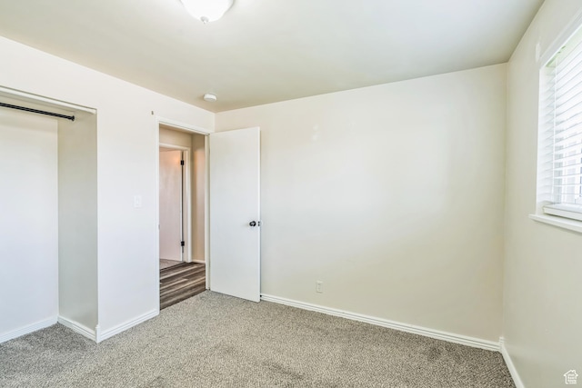 5230 S 5200 W, Kearns, UT 84118 - unfurnished bedroom with light colored carpet, multiple windows, baseboards, and a closet
