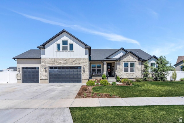 4871 N Mt Nebo Dr, Eagle Mountain, UT 84005 - view of front of property featuring board and batten siding, stone siding, driveway, and an attached garage