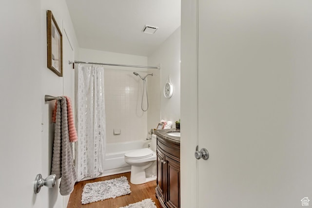 6353 W 3100 S, West Valley City, UT 84128 - bathroom featuring wood finished floors, vanity, shower / bathtub combination with curtain, and toilet