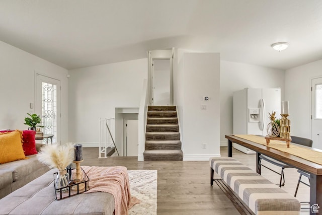 6353 W 3100 S, West Valley City, UT 84128 - living area featuring light wood-style flooring, stairs, plenty of natural light, and baseboards